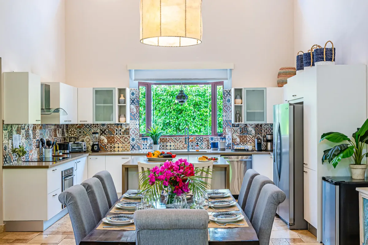 Open kitchen and long dining table with a built-in refrigerator