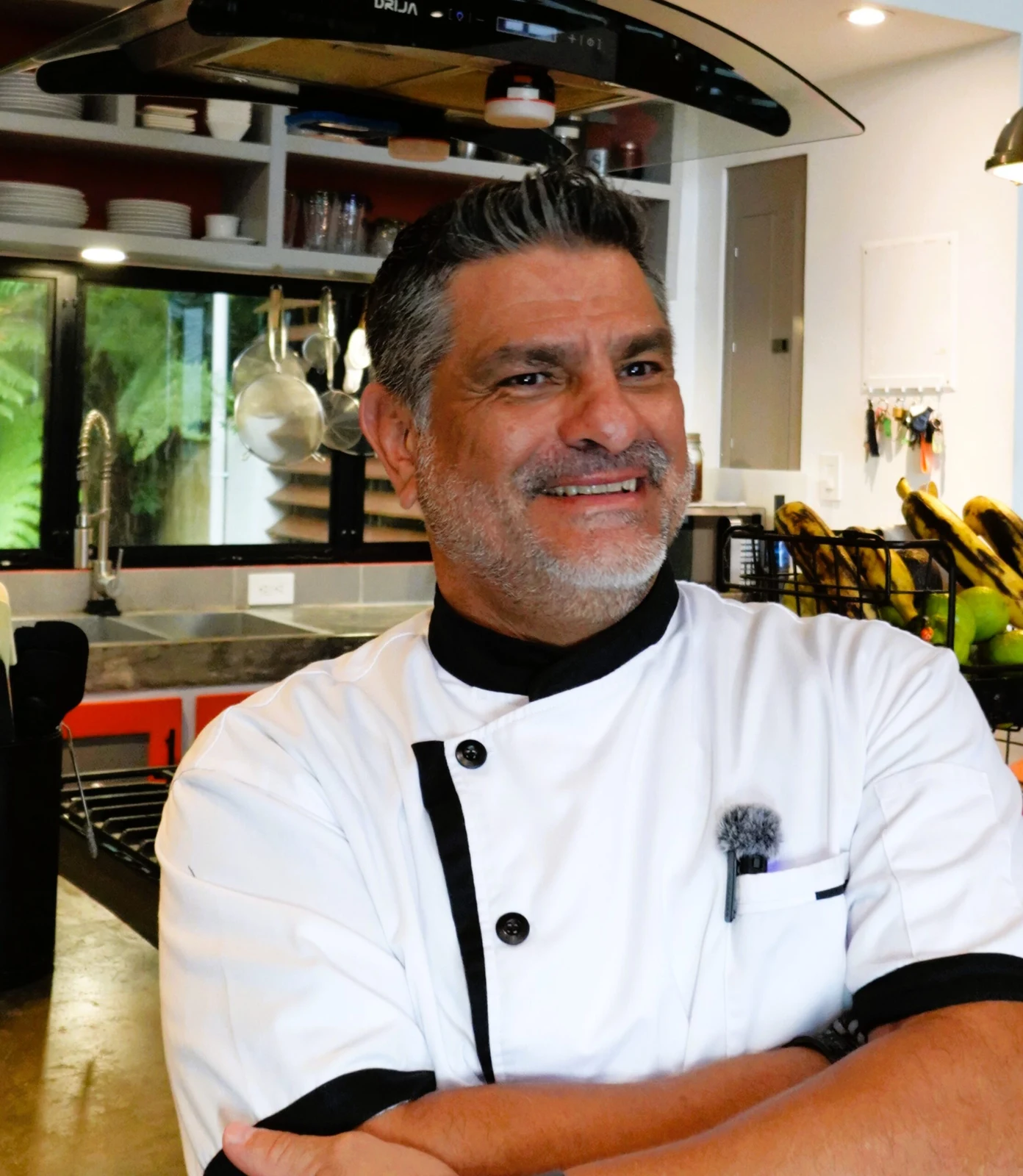 Chef Eddie Cambronero of Eklectic Kitchen smiling in a home kitchen