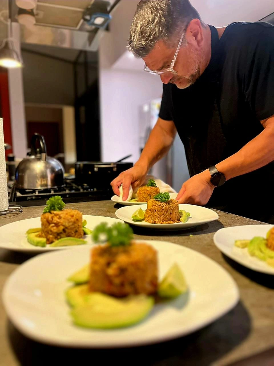 Chef Eddie plating molded rice with avocado for a private dinner