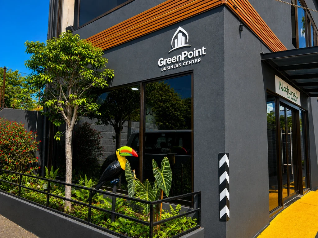 Office entrance at GreenPoint Business Center in Alajuela, with a toucan sculpture in the front garden