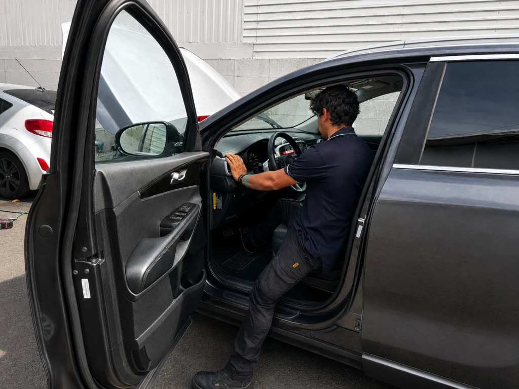 A staff member inspecting the interior of a rental vehicle