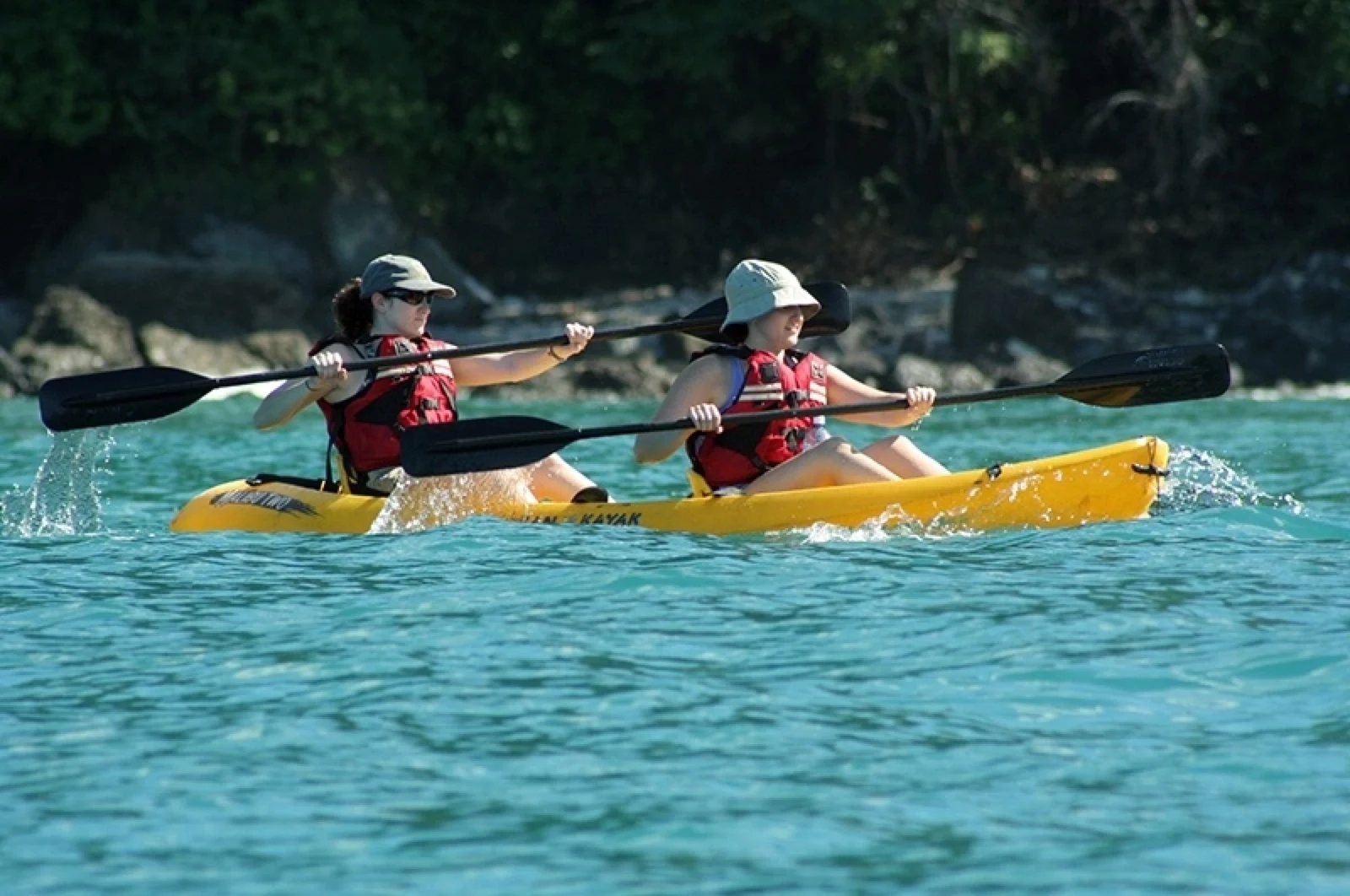 Two guests tandem sea kayaking along the Manuel Antonio coastline