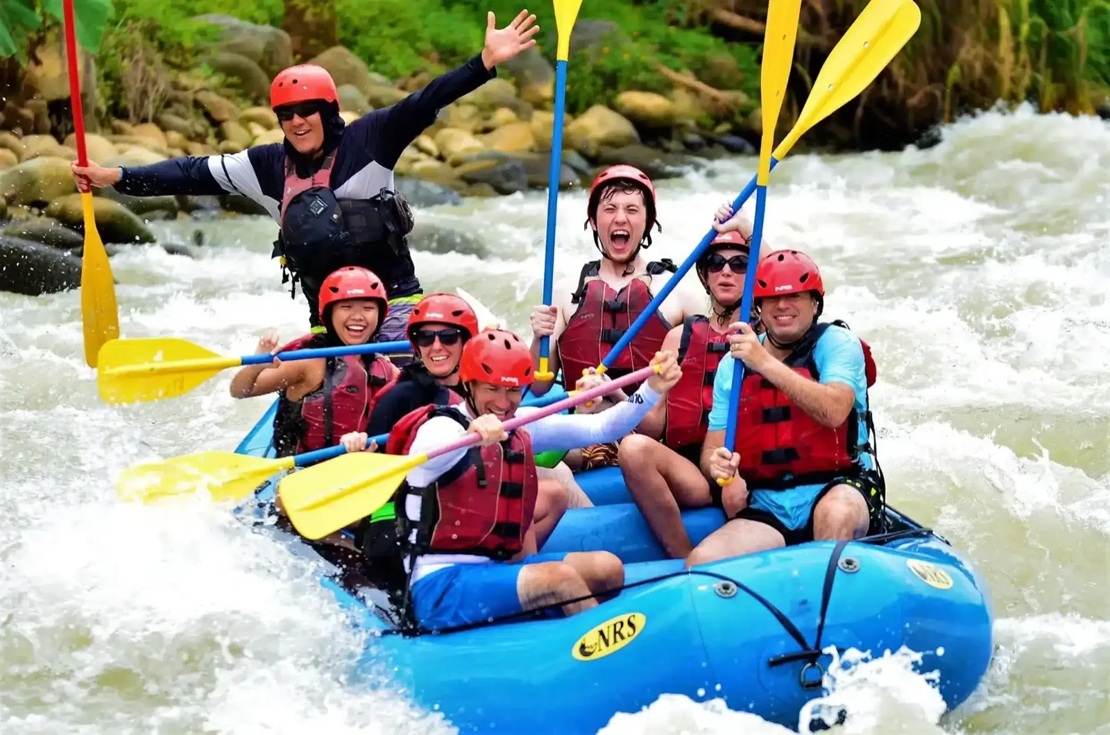 A rafting group paddling through whitewater on the Savegre river
