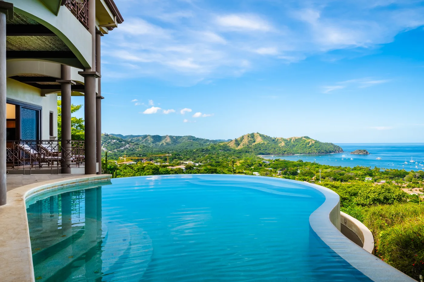 Infinity pool edge looking across the bay toward the headland